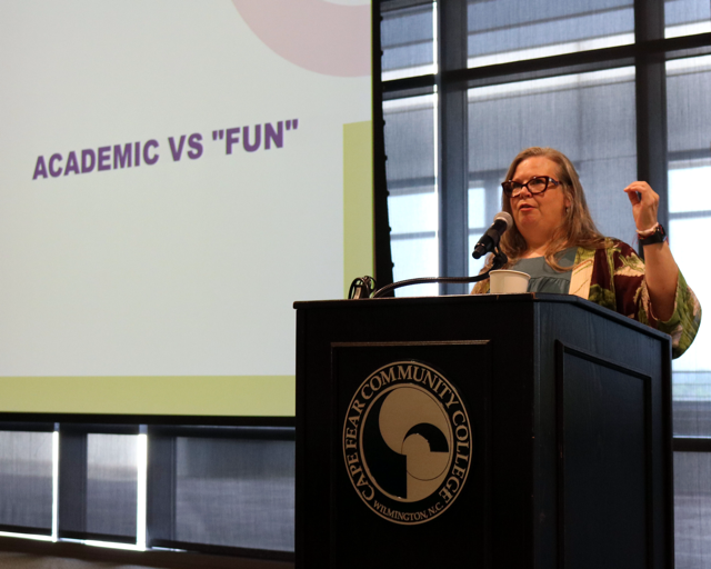 Rebecca Tolley speaking at a podium.