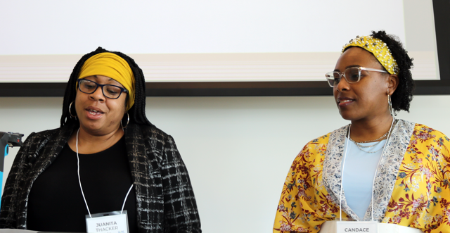 Juanita Thacker (left) and Candace Jacobs (right) presenting in front of a projector screen.